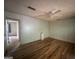 Bedroom with hardwood floors, white paneled walls, ceiling fan, and large closet at 1041 Sandy Ridge Rd, Mcdonough, GA 30252
