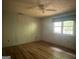 Bedroom featuring hardwood floors, ceiling fan, and a window with lots of natural light at 1041 Sandy Ridge Rd, Mcdonough, GA 30252