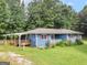 Charming single-story home featuring a covered deck, front porch, and a lush lawn at 1041 Sandy Ridge Rd, Mcdonough, GA 30252
