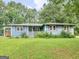 A cozy single-story home with a covered front porch and a well-maintained lawn at 1041 Sandy Ridge Rd, Mcdonough, GA 30252