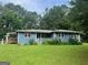 Cozy single-story home with a well-maintained lawn and mature trees in a peaceful setting at 1041 Sandy Ridge Rd, Mcdonough, GA 30252