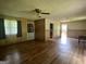 Inviting living room featuring durable laminate flooring, wood paneling and plenty of natural light at 1041 Sandy Ridge Rd, Mcdonough, GA 30252