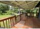 Inviting covered porch with wooden railing, offering a relaxing outdoor space at 1041 Sandy Ridge Rd, Mcdonough, GA 30252