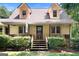 Inviting front porch with wooden steps and decorative bushes leading to the entrance at 292 Selfridge Rd, Mcdonough, GA 30252