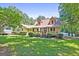 Charming single Gathering home featuring a well-manicured lawn and inviting covered front porch at 292 Selfridge Rd, Mcdonough, GA 30252