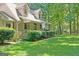 Lush green lawn leading to a quaint single-Gathering home with a covered front porch at 292 Selfridge Rd, Mcdonough, GA 30252
