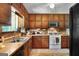 Well-lit kitchen featuring wooden cabinetry, a window over the sink, and essential appliances at 292 Selfridge Rd, Mcdonough, GA 30252