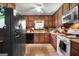 Functional kitchen with wooden cabinets, essential appliances, and ample countertop space at 292 Selfridge Rd, Mcdonough, GA 30252