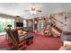 Cozy living room with lots of natural light, featuring a ceiling fan, plush seating and vintage decorations at 292 Selfridge Rd, Mcdonough, GA 30252