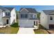 Charming two-story home with a two-car garage and manicured front lawn, perfect for suburban living at 12071 Conrad Cir, Hampton, GA 30228