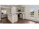 Well-lit kitchen features a spacious island, stainless steel appliances and access to the yard at 12071 Conrad Cir, Hampton, GA 30228