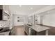 Open-concept kitchen with an island, stainless steel appliances, and hardwood floors at 12071 Conrad Cir, Hampton, GA 30228