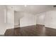 Open-concept living room features hardwood floors, natural lighting, and neutral paint at 12071 Conrad Cir, Hampton, GA 30228