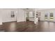 Open-concept living area with hardwood floors, bright lighting, and a seamless flow to the kitchen at 12071 Conrad Cir, Hampton, GA 30228