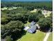 Aerial view of a home with a beautiful pool, set amidst lush greenery and a tree-filled landscape at 403 Chester Piper Rd, Covington, GA 30014