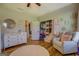A cozy bedroom showcases a comfortable reading nook, cheerful decor, and a well-organized closet at 403 Chester Piper Rd, Covington, GA 30014