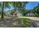 Charming white home with black shutters, well-manicured lawn, and a guest house in the background at 403 Chester Piper Rd, Covington, GA 30014