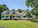 Charming white farmhouse with black accents, inviting front porch, and manicured lawn at 403 Chester Piper Rd, Covington, GA 30014
