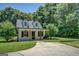 Inviting guest house featuring a covered porch, black shutters, and a well-maintained front yard at 403 Chester Piper Rd, Covington, GA 30014