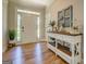 Bright foyer with wood floors, console table, and decor, creating a welcoming entrance at 403 Chester Piper Rd, Covington, GA 30014