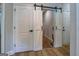 Hallway featuring a sliding barn door and multiple entryways at 403 Chester Piper Rd, Covington, GA 30014