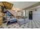 Comfortable living room area featuring wood-look flooring, coffered ceiling and nearby stairway at 403 Chester Piper Rd, Covington, GA 30014