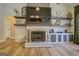 Comfortable living room with a brick fireplace, floating shelves, and modern decor at 403 Chester Piper Rd, Covington, GA 30014