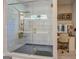 Luxurious primary bathroom with a glass-enclosed shower, tile accents, and a separate vanity area for comfort at 403 Chester Piper Rd, Covington, GA 30014