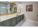 A stylish primary bathroom features a dual-sink vanity with ample storage and a large mirror, perfect for couples at 403 Chester Piper Rd, Covington, GA 30014
