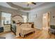 Cozy primary bedroom showcasing tray ceilings, soft lighting, and an en-suite bathroom for a relaxing retreat at 403 Chester Piper Rd, Covington, GA 30014