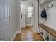 Well-organized mudroom featuring a bench with storage and coat hooks, leading to a bright hallway and bathroom at 403 Chester Piper Rd, Covington, GA 30014