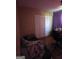 Cozy bedroom with closet, featuring neutral walls and desk space at 8778 Homewood Ct, Riverdale, GA 30274