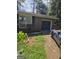 Brick home featuring a blue garage door and a vintage Corvette in the driveway at 8778 Homewood Ct, Riverdale, GA 30274