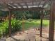Backyard featuring a wooden pergola and lush greenery, creating a serene outdoor space for relaxation and enjoyment at 2202 Springdale Dr, Snellville, GA 30078