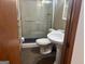 Bathroom with a glass-enclosed shower, tile flooring, and a pedestal sink, providing a functional and clean space at 2202 Springdale Dr, Snellville, GA 30078