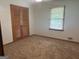 Bedroom featuring a closet, neutral carpet, and natural light, offering a serene space for rest and relaxation at 2202 Springdale Dr, Snellville, GA 30078
