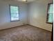 Bedroom featuring neutral carpet and natural light, providing a cozy and versatile space at 2202 Springdale Dr, Snellville, GA 30078