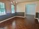 Traditional dining room with hardwood floors, wainscoting, chandelier, and natural light, creating an inviting atmosphere at 2202 Springdale Dr, Snellville, GA 30078