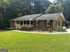 Charming brick home with a well-manicured lawn and inviting front porch perfect for relaxing at 2202 Springdale Dr, Snellville, GA 30078