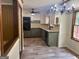Well-lit kitchen area with cabinets, updated appliances, and a view into the dining area at 2202 Springdale Dr, Snellville, GA 30078