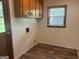 Clean and functional laundry room with wood flooring and built in cabinets at 2202 Springdale Dr, Snellville, GA 30078