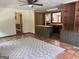 Spacious living room featuring beautiful tile flooring, a ceiling fan, and a view into the kitchen area at 2202 Springdale Dr, Snellville, GA 30078