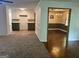 Open living space with carpet flooring that leads to the kitchen and dining area with hardwood flooring at 2202 Springdale Dr, Snellville, GA 30078