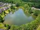 Aerial view of a neighborhood lake surrounded by houses and lush greenery and trees at 9132 Overlook Dr, Jonesboro, GA 30238