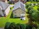 Aerial view of backyard with green lawn and trees, featuring solar panels on roof at 9132 Overlook Dr, Jonesboro, GA 30238