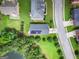 Aerial view of home with solar panels, a backyard, and a tree-lined residential street at 9132 Overlook Dr, Jonesboro, GA 30238