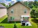 The home's backyard shows a small concrete patio, grill, and a well-maintained lawn at 9132 Overlook Dr, Jonesboro, GA 30238