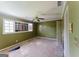 Standard bedroom featuring ceiling fan and a window; ready for renovation at 145 Windy Ridge Ct, Fayetteville, GA 30214
