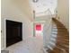 The open foyer has tile floors, a winding staircase, and walls needing repair at 145 Windy Ridge Ct, Fayetteville, GA 30214