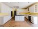 Kitchen with white cabinets, black oven, cooktop island; needs renovation at 145 Windy Ridge Ct, Fayetteville, GA 30214
